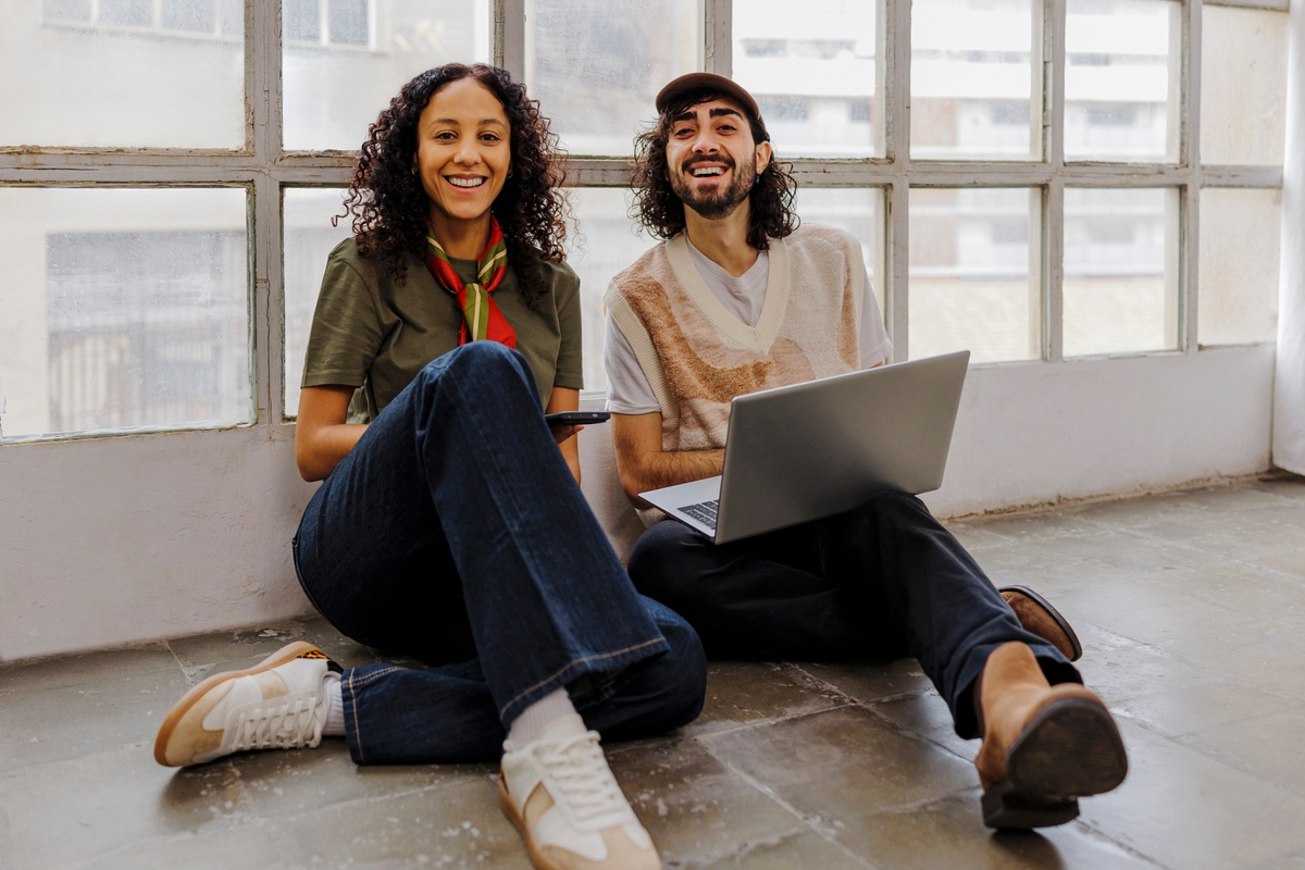 Trendy man and women sat on floor