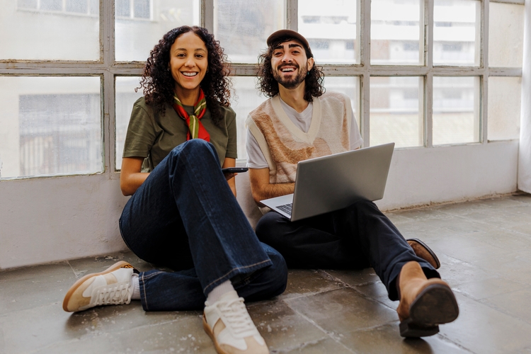 Trendy man and women sat on floor